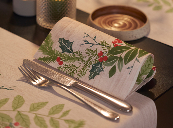Folded Christmas napkin with cutlery and a matching table runner
