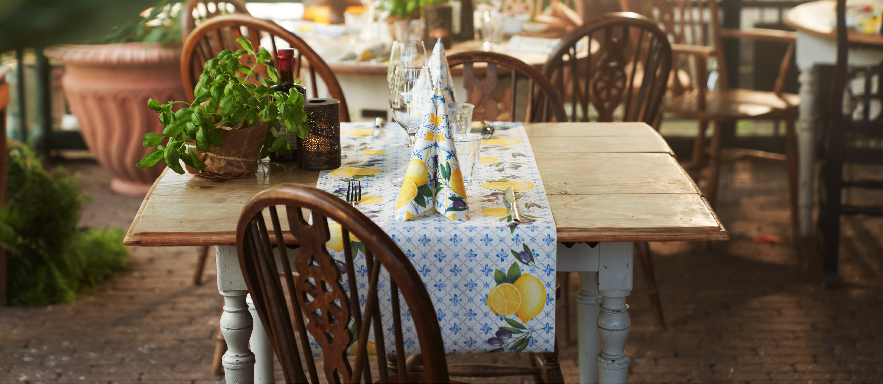 A table set with the Mediterrian napkin and table cover